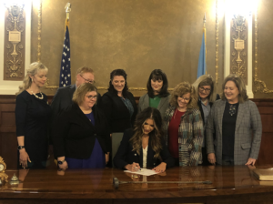 Supporters of Senate Bill 70 attend the signing of the bill by Governor Noem.